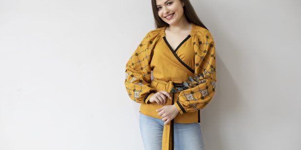 medium-shot-smiley-woman-wearing-ukranian-shirt